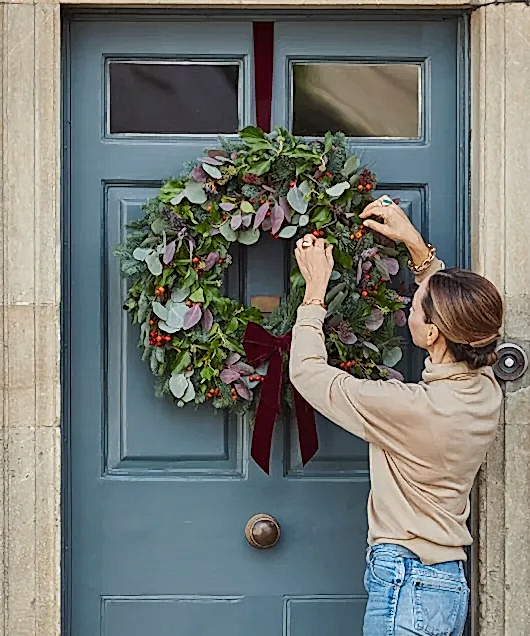 putting a wreath on a door
