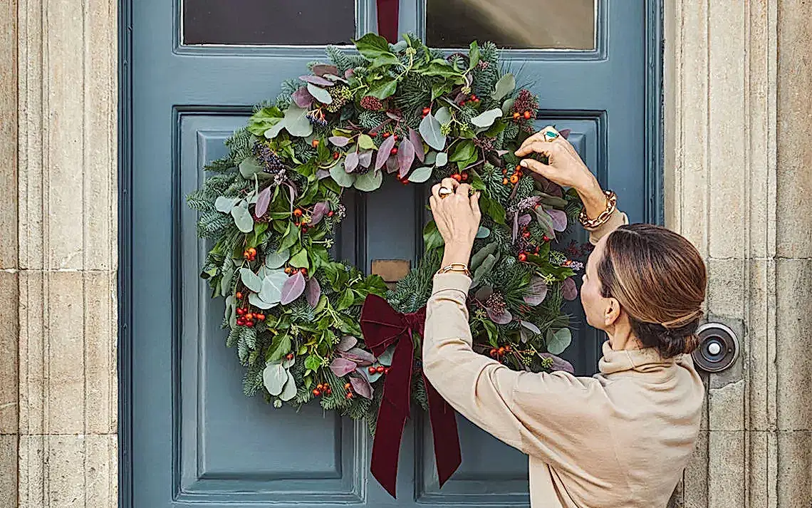 putting a wreath on a door
